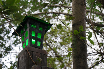 Old street lamp with a dim green light.