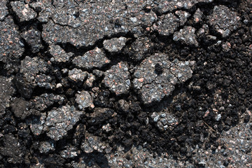 The texture is broken into pieces of asphalt from above