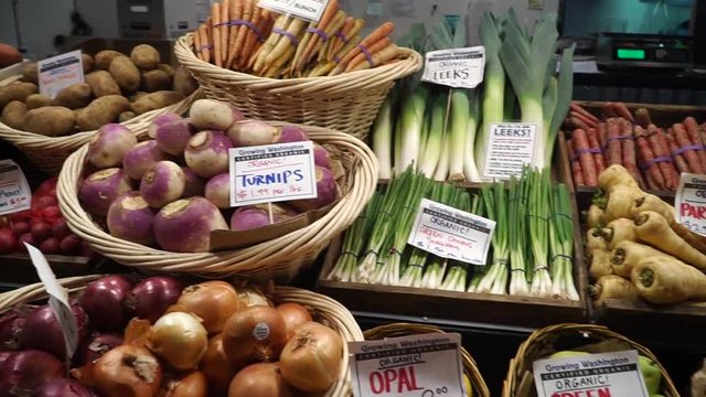 Fresh fruits and vegetables lie on the counter in a market