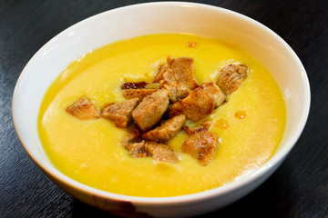 Yellow cream soup of beans with roasted meat
