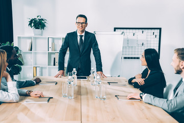 multiethnic businesspeople having conversation in modern conference hall