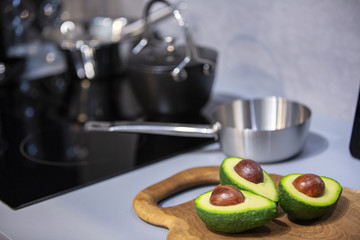 Sliced Avocado on a wooden Board in a modern kitchen 