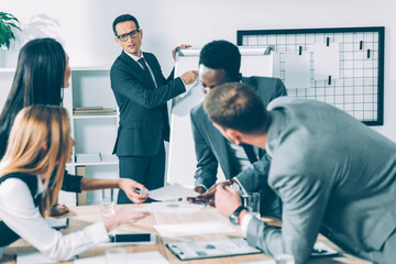 multiracial businesspeople having conversation in conference hall