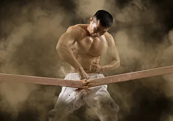 Tapeten Kampfkunst Karate-Mann bricht mit Hand Holzbrett