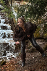 girl with a dagger with a dagger near a waterfall