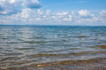 Calm beautiful landscape of blue lake and white clouds