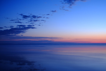 Naklejka na ściany i meble Beautiful sunset over sea with reflection in water.