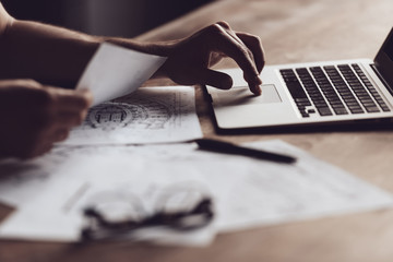 Close up Man Hands Using Laptop on Wooden Table