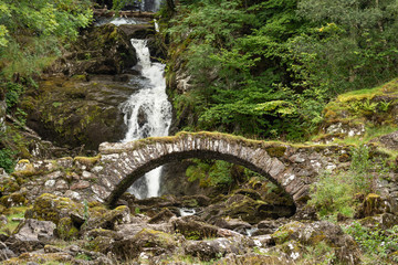 Ancient Roman bridge and waterfalls at Glen Lyon, Perthshire, Scotland.
