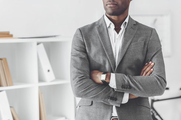 cropped image of african american businessman with crossed arms