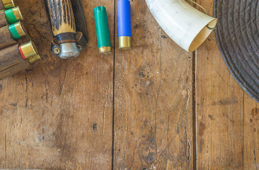 Hunting equipment on vintage wooden background with copy space