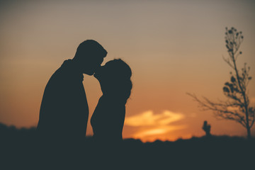 loving couple in silhouette on the sunset