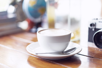 A cup of coffee latte on the wood table.