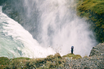 Huge waterfall and a small man
