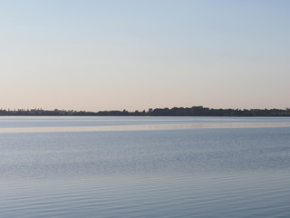 Quiet sun set over artificial european Goczalkowice Reservoir in Poland with beauty blue sky on landscape