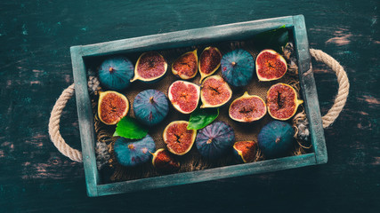 Fig. Fresh fruit figs in a wooden box. Free space for text. Top view.