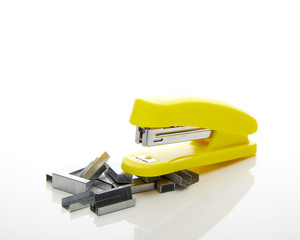 Yellow stapler on the white