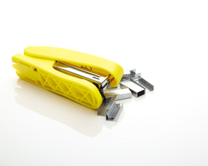Yellow stapler on the white