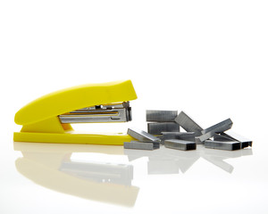 Yellow stapler on the white