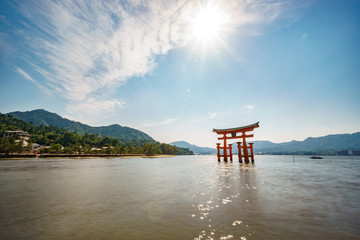Torii gate on high tide and sun on top of the sky