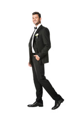 handsome young groom in stylish suit isolated on white