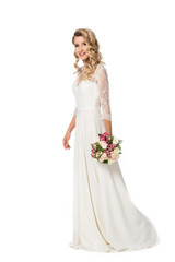 smiling bride holding bouquet and looking at camera isolated on white