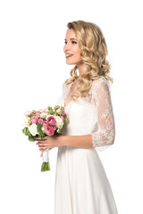 happy bride holding bouquet and looking away isolated on white
