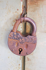 Old rusty closed lock on the door