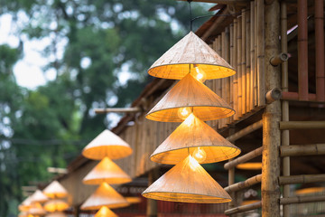 Vietnamese traditional conical hats hanging on wire for decoration.