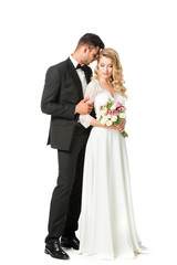 beautiful young bride and groom cuddling isolated on white