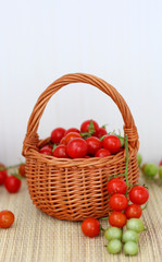 Fototapeta na wymiar basket with red and green cherry tomatoes