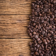 Coffee beans on old wood plank