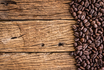 Coffee beans on old wood plank