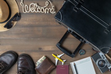 Old black vintage suitcase with welcome text