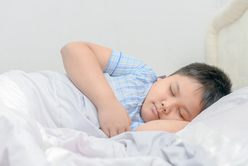 Obraz na płótnie Canvas Obese fat boy sleeping on bed,