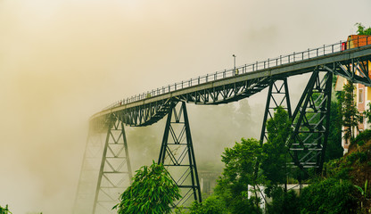 The railroad track train in the mist on old iron bridge. Scary, halloween, Empty lonely solitary concept.