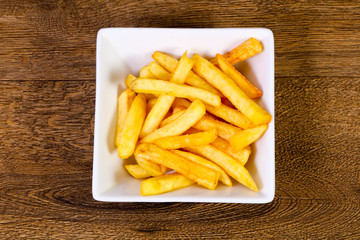 French potato over wooden background