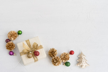 Fototapeta na wymiar Christmas background. Christmas decoration and gift box decorated with golden ribbon on white background. Top view, copy space.