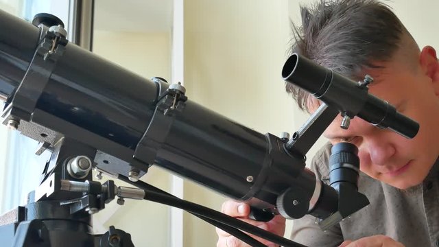 Man looking at the stars with telescope. Astronomy work