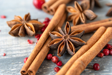 anise seeds, cinnamon sticks and pink pepper - spice  for cooking meats, cakes or mulled wine on wooden table, selective focus and copyspace, Christmas 2019, new year 2019