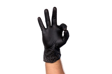 Male hand in black glove shows gesture ok. Isolate on white background. The concept of a successful cleaning firm