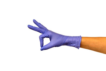 Female hand in lilac glove shows gesture ok. Isolate on white background. The concept of a...