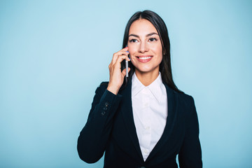 Nice to hear you. Happy beautiful young brunette business woman is talking on mobile phone with...