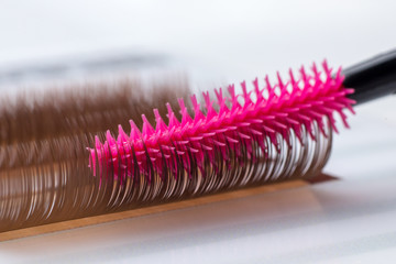 Eyelash brown extension procedure. Set Lashes close up pink comb