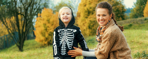 mother and child among Halloween pumpkin Jack O’Lantern