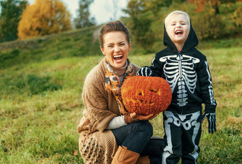 mother and child showing Halloween pumpkin Jack O’Lantern © Alliance