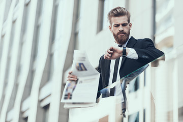 Serious Businessman Reading Newspaper Outdoor