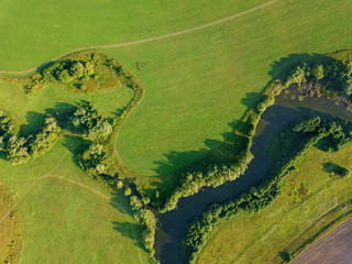 Aerial drone view, of the river among the fields. The middle band of Russia.