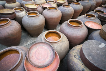 Jars of processing soybean jam made by traditional outdoor way under natural sunlight