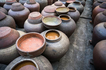 Jars of processing soybean jam made by traditional outdoor way under natural sunlight